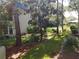 Manicured backyard with lush green grass and surrounding natural shrubs and trees at 1975 W Bay Dr # 207, Largo, FL 33770