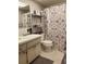 Functional bathroom with a vanity sink, mirror, and a shower/tub combination with a patterned curtain at 1975 W Bay Dr # 207, Largo, FL 33770