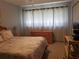 Cozy bedroom with carpet flooring and bright curtains at 1975 W Bay Dr # 207, Largo, FL 33770