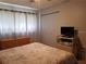 Bedroom offering a neutral carpet, closet space, and bright curtains at 1975 W Bay Dr # 207, Largo, FL 33770