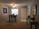 Inviting dining area with a modern table set and a window, complemented by neutral carpet and paint at 1975 W Bay Dr # 207, Largo, FL 33770