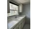 Practical kitchen with double sinks, storage, and natural light at 1975 W Bay Dr # 207, Largo, FL 33770