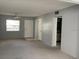 Spacious living room with neutral paint, carpet and ample natural light at 1975 W Bay Dr # 207, Largo, FL 33770