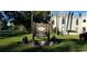 Belleair Oaks Condominiums sign surrounded by lush green grass and manicured landscaping at 1975 W Bay Dr # 207, Largo, FL 33770