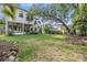 Expansive backyard with covered patio and lush landscaping surrounding the property at 207 Chippewa Ave, Tampa, FL 33606