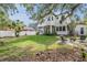 Large backyard with patio, lush green grass, and a beautiful two-story home at 207 Chippewa Ave, Tampa, FL 33606