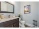 Powder room featuring a framed mirror, vanity with a light countertop, and a toilet at 207 Chippewa Ave, Tampa, FL 33606