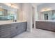 Bathroom showcasing double vanities with granite counters and ample natural light at 207 Chippewa Ave, Tampa, FL 33606