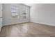 Bedroom featuring light hardwood floors, natural light from two windows and base trim at 207 Chippewa Ave, Tampa, FL 33606