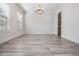 Dining room featuring modern chandelier, wood look flooring, and a butler's pantry with a wine fridge at 207 Chippewa Ave, Tampa, FL 33606