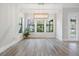 Bright dining room with large windows, modern lighting, and wood-look tile flooring at 207 Chippewa Ave, Tampa, FL 33606