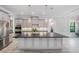 Well-lit kitchen with large island, stainless appliances, pendant lights and gray cabinets at 207 Chippewa Ave, Tampa, FL 33606