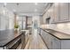 Open kitchen layout showcasing stainless steel appliances, large center island and gray cabinets at 207 Chippewa Ave, Tampa, FL 33606