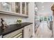 Modern kitchen with gray cabinetry, wine fridge, stainless steel appliances, and wood-look tile flooring at 207 Chippewa Ave, Tampa, FL 33606