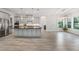 Open kitchen features a large island with black countertop, light gray cabinetry and stainless steel appliances at 207 Chippewa Ave, Tampa, FL 33606