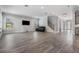 Spacious living room featuring wood-look tile flooring, a staircase, and modern furnishings at 207 Chippewa Ave, Tampa, FL 33606