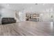 Open-concept living room and kitchen with stairs and wood-look flooring at 207 Chippewa Ave, Tampa, FL 33606