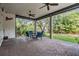 Covered outdoor living space with brick flooring and views of the lush backyard at 207 Chippewa Ave, Tampa, FL 33606