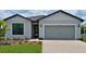 Charming single-story home featuring a two-car garage and manicured front lawn at 2535 Charter Oak Dr, North Port, FL 34289