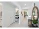 Hallway with neutral decor, leading to bedrooms and living areas, enhanced by natural light and stylish accents at 2535 Charter Oak Dr, North Port, FL 34289
