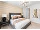 Modern bedroom with a large upholstered bed, decorative lighting, and a serene ambiance at 2535 Charter Oak Dr, North Port, FL 34289