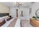 Well-lit bedroom with decorative lighting, a dresser, and an ensuite bathroom at 2535 Charter Oak Dr, North Port, FL 34289