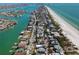Aerial view of a coastal community that highlights the waterfront homes, pristine beaches, and vibrant waterways at 2700 Pass A Grille Way, St Pete Beach, FL 33706