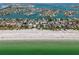 Expansive aerial view showcasing beachfront homes with crystal-clear waters and white sand at 2700 Pass A Grille Way, St Pete Beach, FL 33706