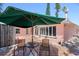Relaxing outdoor patio area with tiled flooring, umbrella, and seating at 2700 Pass A Grille Way, St Pete Beach, FL 33706