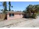 Exterior side view of cozy home showcasing its street access and surroundings at 2700 Pass A Grille Way, St Pete Beach, FL 33706