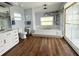 Bright bathroom featuring a large tub, shower with glass door, vanity, toilet, and artistic touches at 2810 Norwood Ln, Venice, FL 34292
