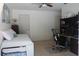 Bedroom with a neutral color scheme featuring a twin bed, ceiling fan and functional desk area at 2810 Norwood Ln, Venice, FL 34292