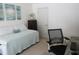 Comfortable bedroom with a twin bed, neutral carpet, and a small work area at 2810 Norwood Ln, Venice, FL 34292