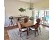 Comfortable dining area with table and chairs, with an outdoor pool view from sliding glass doors at 2810 Norwood Ln, Venice, FL 34292