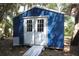 Charming Shed exterior with double doors, siding, and natural surroundings at 2810 Norwood Ln, Venice, FL 34292