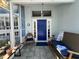 Inviting front porch featuring tile floors, comfortable seating, decor, and natural light at 2810 Norwood Ln, Venice, FL 34292