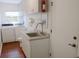 Convenient laundry room with sink, cabinets, and modern washer and dryer at 2810 Norwood Ln, Venice, FL 34292