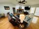 Open-concept space featuring hardwood floors, a fireplace, living room seating, and a dining area at 2860 58Th S Cir, St Petersburg, FL 33712