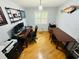 Well-lit home office with hardwood floors, multiple desks, a window with shutters, and ample workspace at 2860 58Th S Cir, St Petersburg, FL 33712