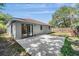 View of the backyard featuring a concrete patio and large sliding glass doors into the home at 3208 E 8Th Ave, Tampa, FL 33605