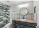 Updated bathroom featuring a granite countertop and shower with beautiful tiling and modern fixtures at 3208 E 8Th Ave, Tampa, FL 33605