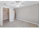 Bedroom with a ceiling fan, open closet, and neutral-toned walls and light-colored wood flooring at 3208 E 8Th Ave, Tampa, FL 33605