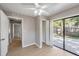 Bedroom with a ceiling fan, sliding door, and hardwood floors at 3208 E 8Th Ave, Tampa, FL 33605
