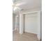 Bedroom with open closet, ceiling fan, light-colored walls, and wood flooring at 3208 E 8Th Ave, Tampa, FL 33605