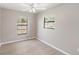 Bedroom with neutral-colored walls, wood flooring, ceiling fan, and two windows offering outdoor views at 3208 E 8Th Ave, Tampa, FL 33605