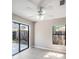 Bright bedroom featuring a sliding door leading to the backyard, white walls, and hardwood floors at 3208 E 8Th Ave, Tampa, FL 33605