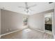 Bedroom featuring hardwood floors, neutral wall paint, and access to an adjacent bathroom at 3208 E 8Th Ave, Tampa, FL 33605
