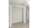 Bedroom with an open closet, light-colored walls, wood flooring, and natural light from the hallway at 3208 E 8Th Ave, Tampa, FL 33605
