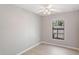 Bedroom featuring a ceiling fan, light-colored floors, and a window with a view of the outdoors at 3208 E 8Th Ave, Tampa, FL 33605