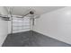 Spacious garage featuring sealed concrete flooring, painted walls, and an automatic door opener at 3208 E 8Th Ave, Tampa, FL 33605